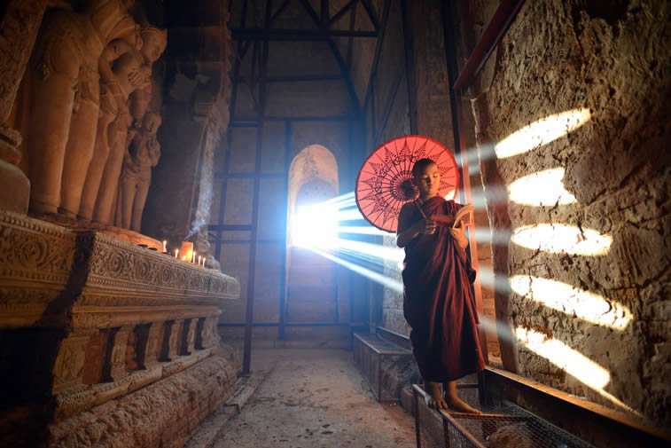 young monk at bagan myanmar indoor sunrays