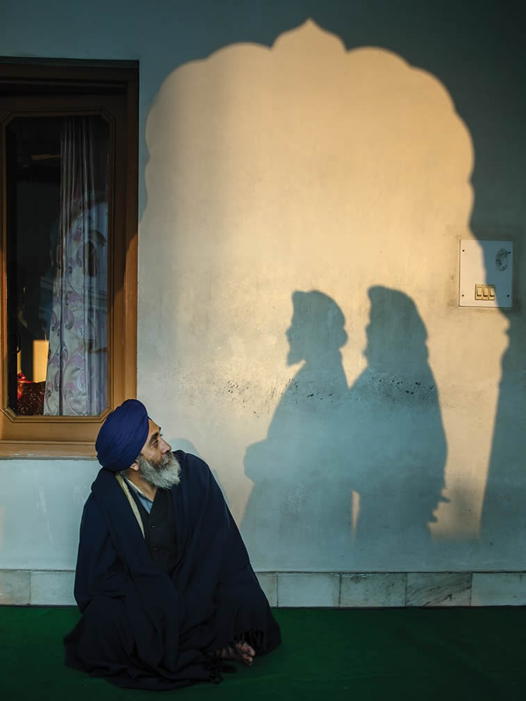 a man looking towards two shadows amritsar punjab