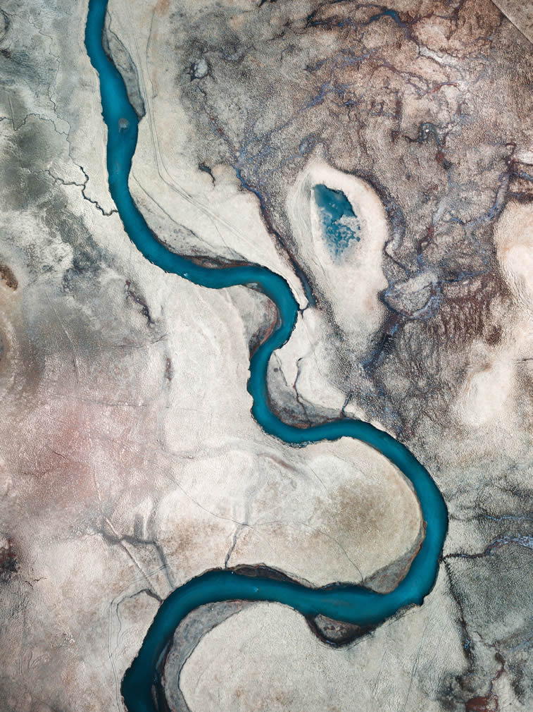air veiw blue rivers appear vividly against the volcanic plains in Iceland