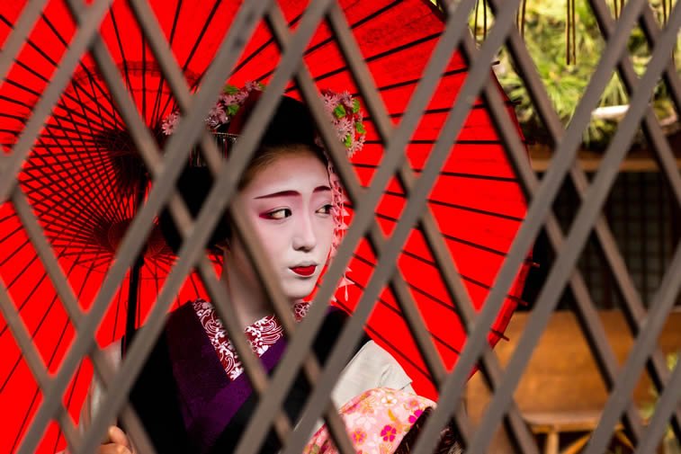 The half-painted lips indicates that this 17-year-old geisha in training with half-painted lips