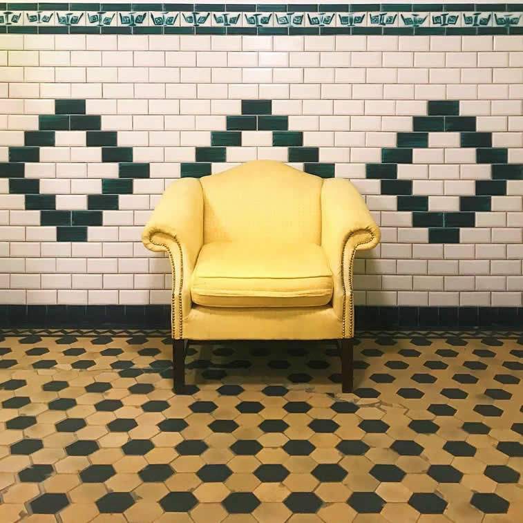 yellow arm chair on tiles