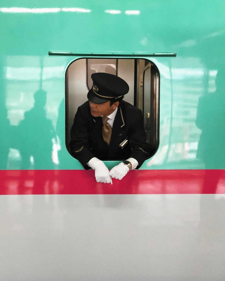 man looking through a train window we anderson style